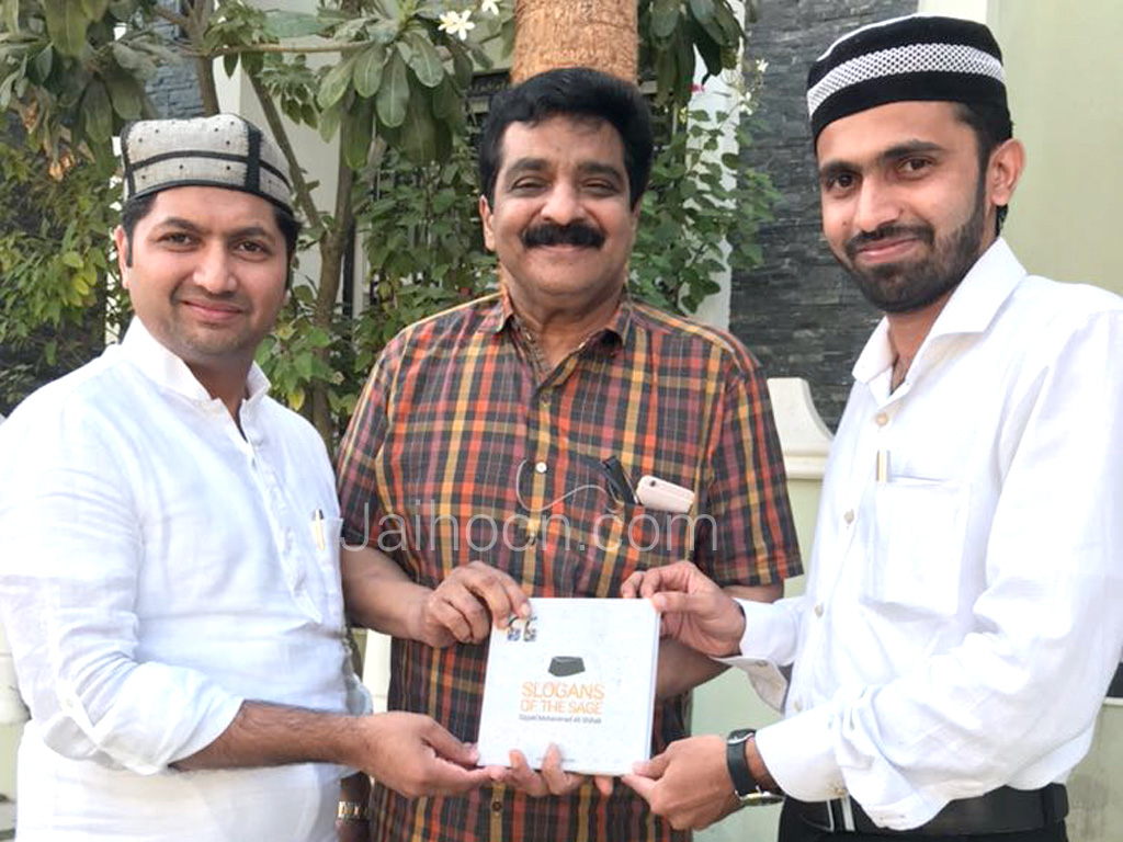 Presenting the book, Slogans of the Sage, to Dr. MK Muneer, writer and politician from Kerala